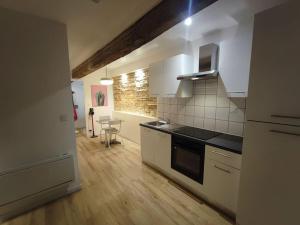 a kitchen with white appliances and a table in it at Appartement T2 - RDC in Seysses