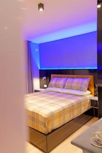 a bedroom with a large bed with a purple ceiling at House Natalia in Sarandë