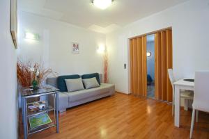 a living room with a couch and a table at Apartments Richard 2319 in Pješčana Uvala 