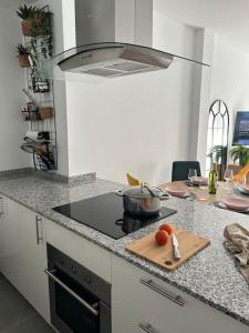 a kitchen with a stove and a cutting board at Sol, playa y relax en Fuengirola in Fuengirola
