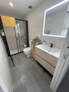 a bathroom with a sink and a toilet and a mirror at Sol, playa y relax en Fuengirola in Fuengirola
