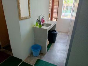 a bathroom with a sink and a trash can at HASD GUESTHOUSE in Kampong Tebing Rabak