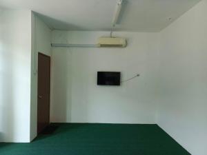 a room with a white wall and a television on the wall at HASD GUESTHOUSE in Kampong Tebing Rabak