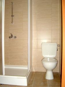 a bathroom with a toilet and a shower at Sun Palace Home Apartments in Sunny Beach
