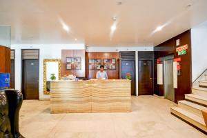 a man standing at a counter in a lobby at The Raj - New Delhi in New Delhi