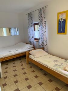 a room with two beds and a mirror at Agroturystyka Pod Podkową in Mrągowo