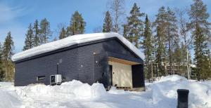 a building covered in snow with snow around it at Villa Noel in Ylläsjärvi