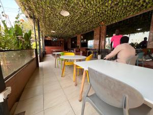 a restaurant with tables and people sitting at tables at EASTERN PLAZA HOTEL in Juba