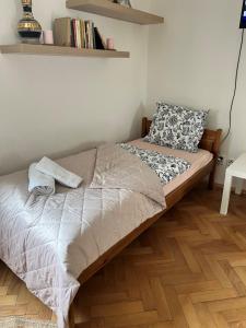 un letto in una camera da letto con pavimento in legno di Apartmán Simmy a Modřice