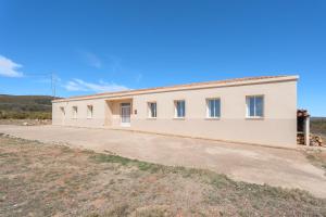 a large white building with a lot of windows at Antiga escola Pla del Sabater in Culla