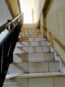a stairway leading up to a door in a building at Ifrazim palem in Karang Tengah