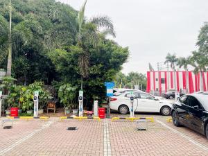 a parking lot with cars parked in front of a building at Yiho Hotel Xiamen Huli in Xiamen