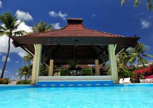 a gazebo next to a swimming pool at Aqua Resort Club Saipan in Saipan