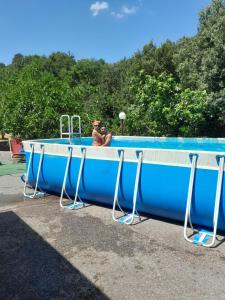 een man die een foto neemt van een grote blauwe pool bij Oasi dell' Etna in Piedimonte Etneo