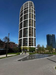 a tall building with a person walking in front of it at Apartmán v Starom meste Sky Park s parkovaním in Bratislava