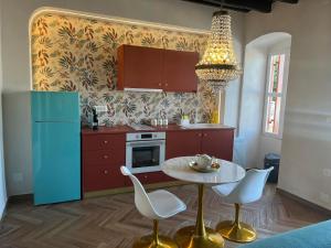 a kitchen with a table and chairs and a refrigerator at Annikas Port View-Ground in Symi