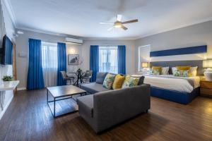 a hotel room with a bed and a couch at Park Lane Boutique Aparthotel in St. Paul's Bay