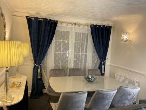 a dining room with a table and chairs and a window at Stunning 4-Bed House in Rochester in Rochester