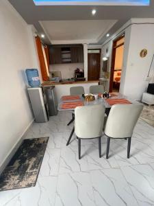 a kitchen with a table and chairs in a room at Ankar Homes, California 2 in Nanyuki