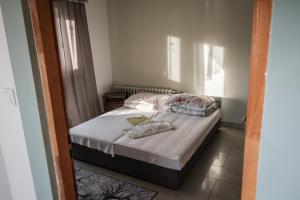 a small bedroom with a bed and a window at Zajazd Izabela in Żywiec