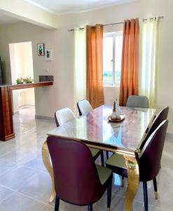 a dining room with a table and chairs at Sunset Home 2B (Gated) in Higuey