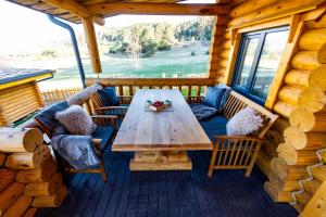 a table on the deck of a log cabin at Kare Luxury Chalets in Tsigov Chark