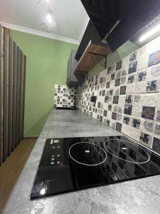 a kitchen with a stove top oven in a room at ციბენა • Tsibena in Ambrolauri