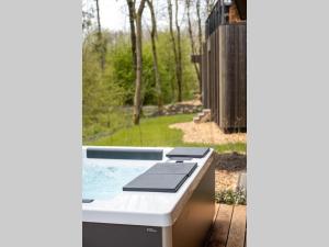 a hot tub in a backyard with a window at De Parel - Mystical spaces to discover! in Zeewolde