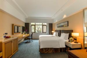 Postel nebo postele na pokoji v ubytování Yiho Hotel Xiamen Huli + 20 fotografií