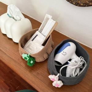 a wooden table with two wii controllers in baskets at Tree House Sukhumvit 39 Phromphong Bangkok in Khlong Toei