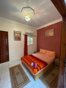 a bedroom with a bed in a room at Riad Hicham in Marrakesh