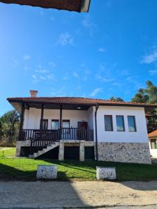 a house with a porch and a roof at Вила Мариам Villa Mariam in Batak