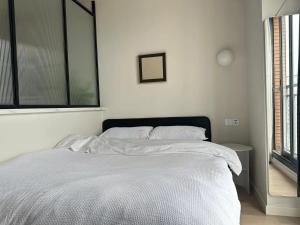 Un pat sau paturi într-o cameră la Tongji Jiayuan Apartment
