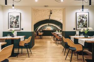 a dining room with tables and chairs at Stokker Hotel in Oradea