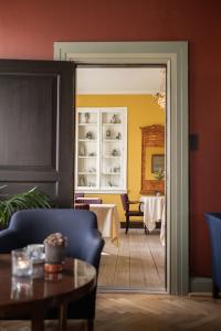 a door leading into a dining room with a table at Brøndums Hotel in Skagen