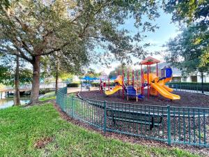 a playground with a slide in a park at Sunshine Retreat 4 Bed Town Home-4017VBD in Kissimmee