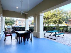 a patio with a table and chairs on a patio at Sunshine Retreat 4 Bed Town Home-4017VBD in Kissimmee