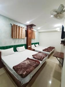 Voodi või voodid majutusasutuse Green leaf Hotel toas