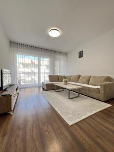 een woonkamer met een bank en een tafel bij City Center 1bedroom in Ferizaj