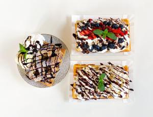 three different plates of desserts on a white table at Ranczo Na Sówce in Ciechanowiec