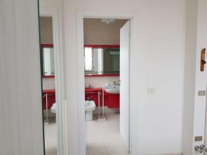 a bathroom with a toilet and a sink and a mirror at IRIS Bilocale Centro Città in Busto Arsizio +41 photos