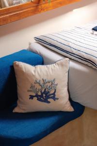 a pillow with a tree design on it next to a bed at Charming sailing boat - Le dimore di Ines in Bari