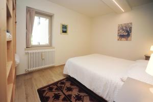 Katil atau katil-katil dalam bilik di Appartamento Ginepro