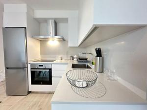 a kitchen with a counter with a sink and a refrigerator at New Port, Free Parking YBH 5A in Vigo