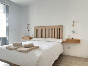 a bedroom with a large bed with two towels on it at New Port, Free Parking YBH 5A in Vigo