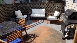 a patio with a grill and chairs and a table at Commercial St Private Patio Dog Welcome in Provincetown