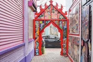 a gate in a alley with a car in the background at Commercial St Private Patio Dog Welcome in Provincetown