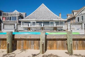 a wooden fence in front of a house at Beachfront on Commercial St Dog Friendly in Provincetown