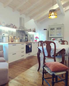 a kitchen with a table and a chair in a room at Totolos home in Lazaratika Corfu in Áyios Pandeleḯmon