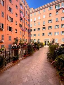 a large building with a courtyard with potted plants at Casetta Roma San Giovanni in Rome